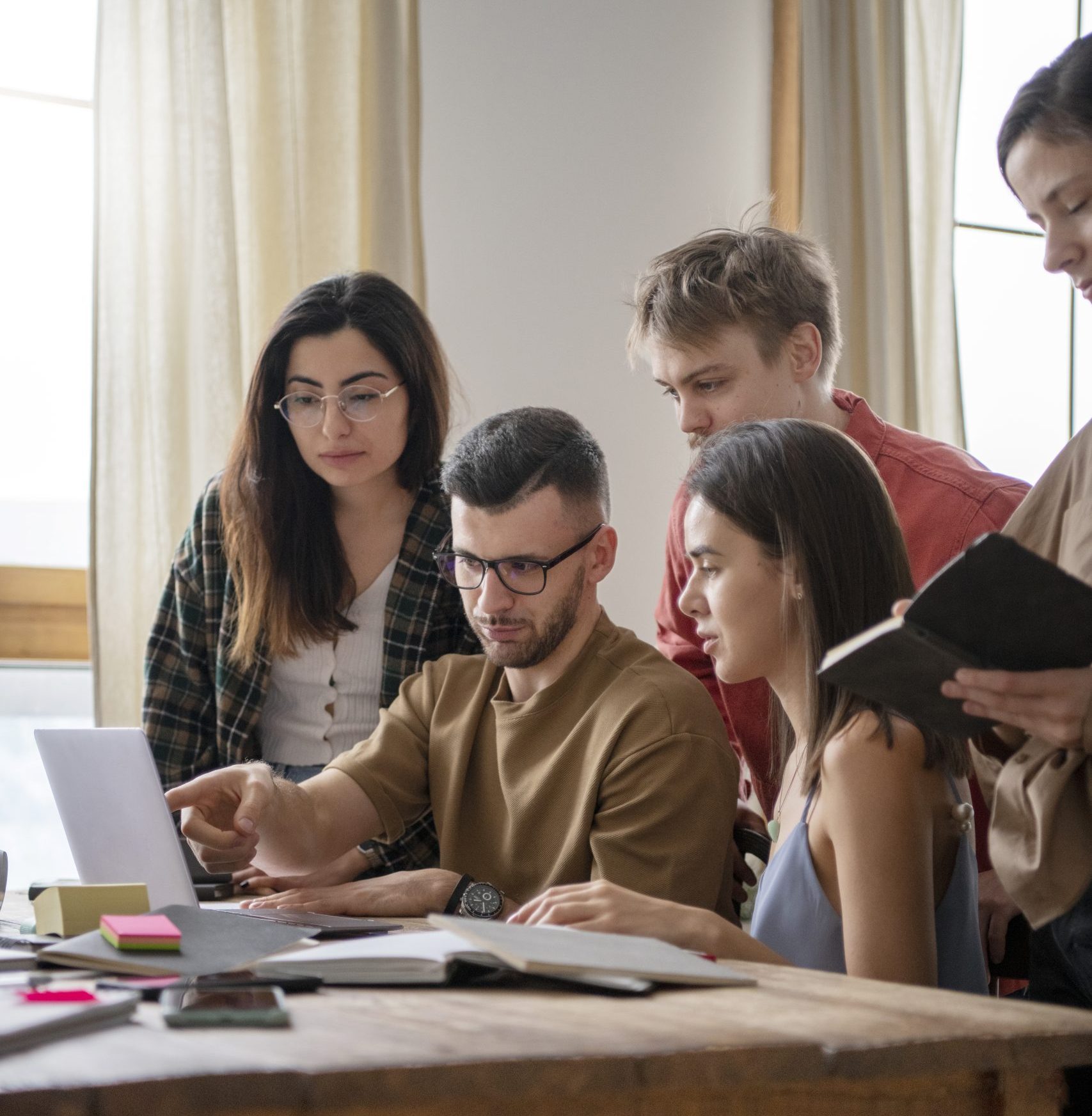 Colleagues Reading Using Laptop Study Session